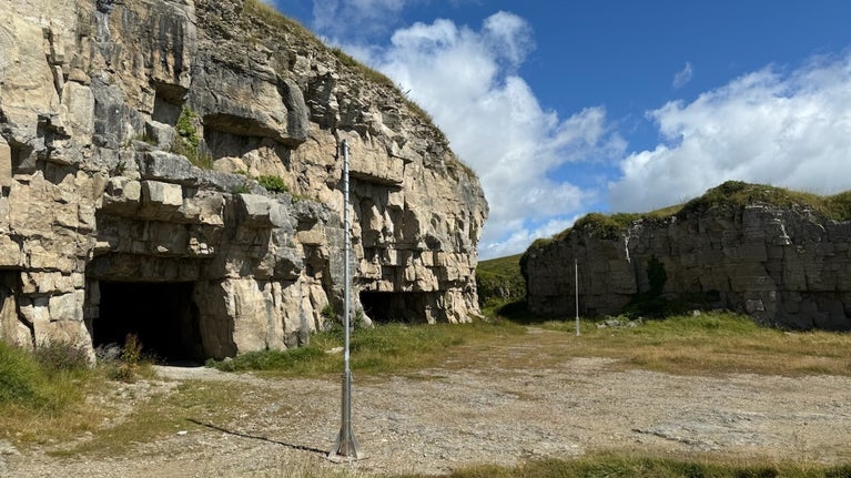 Winspit Quarry with poles drilled into the rocks which hold bat detectors.